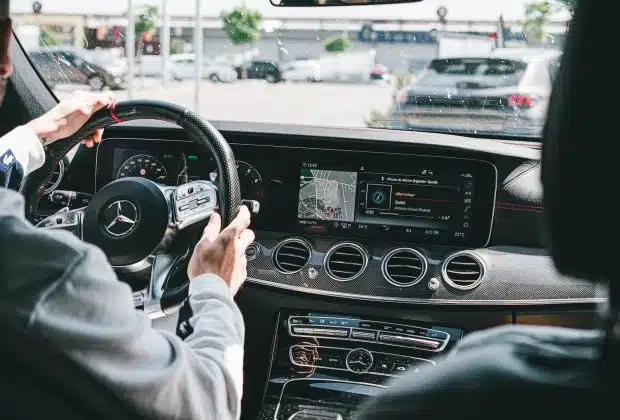 person in gray long sleeve shirt driving car