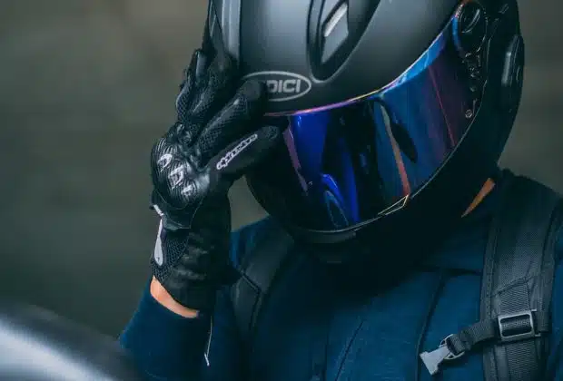 person in black helmet and blue jacket